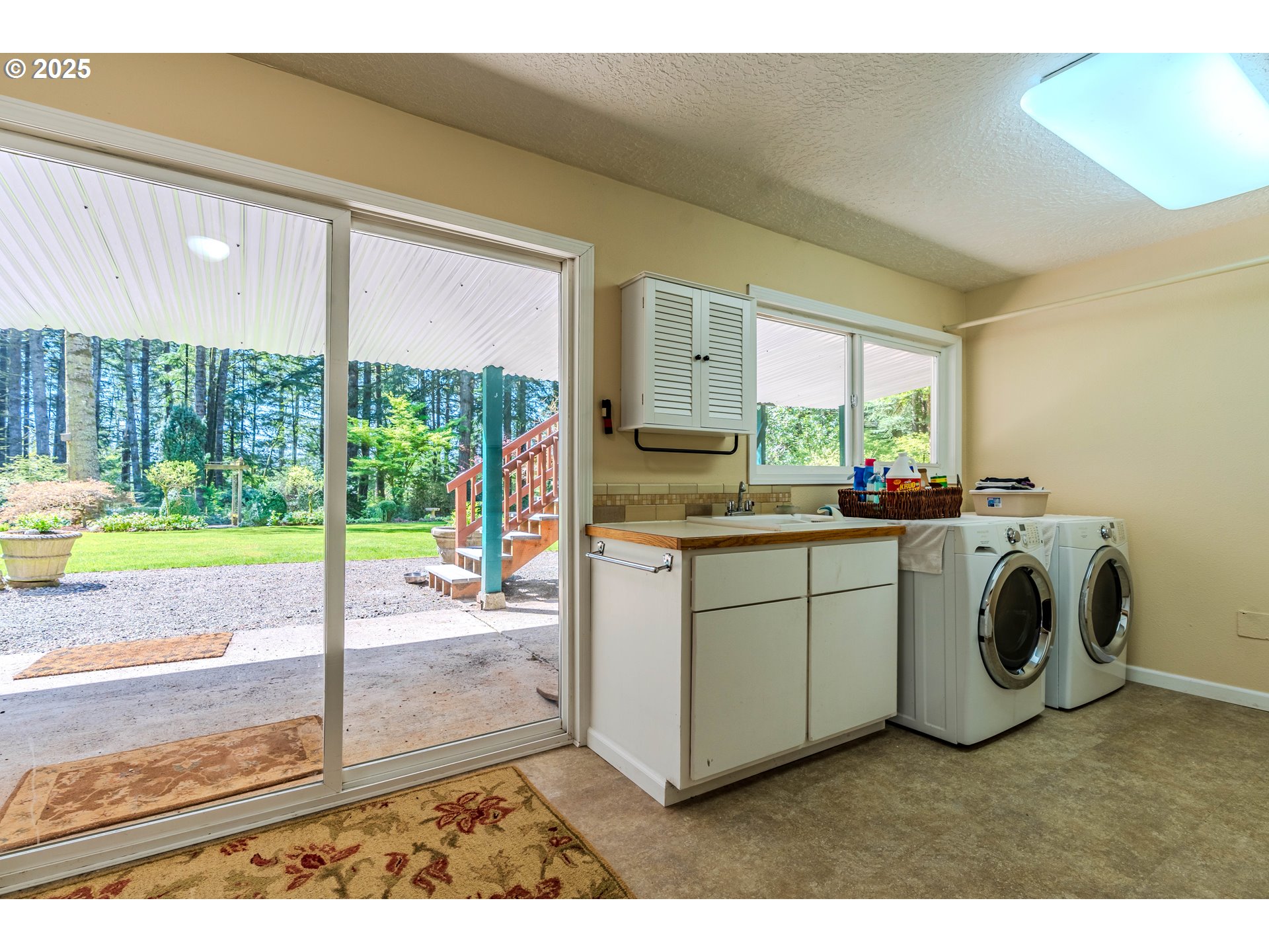 41920 Southeast Gordon Creek Road Corbett, OR 97019 - Photo 24 of 48 a utility room with cabinets dryer and washer