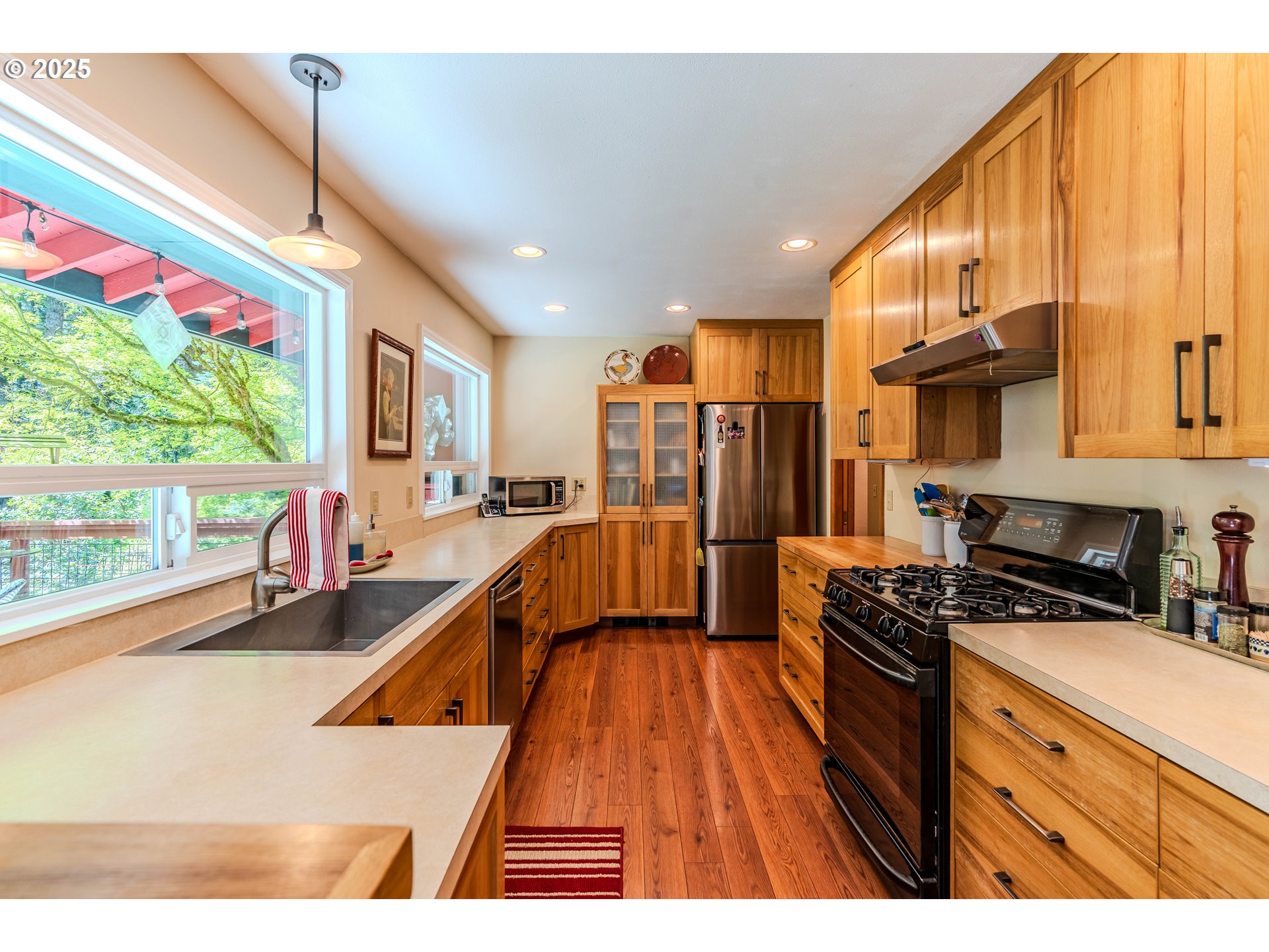 41920 Southeast Gordon Creek Road Corbett, OR 97019 - Photo 9 of 48 a kitchen with stainless steel appliances a stove a refrigerator sink and cabinets