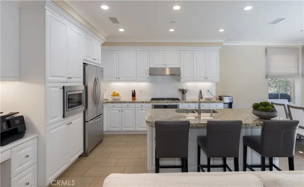 a kitchen with a sink microwave and cabinets