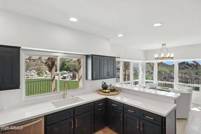 a kitchen with stainless steel appliances granite countertop a sink and cabinets