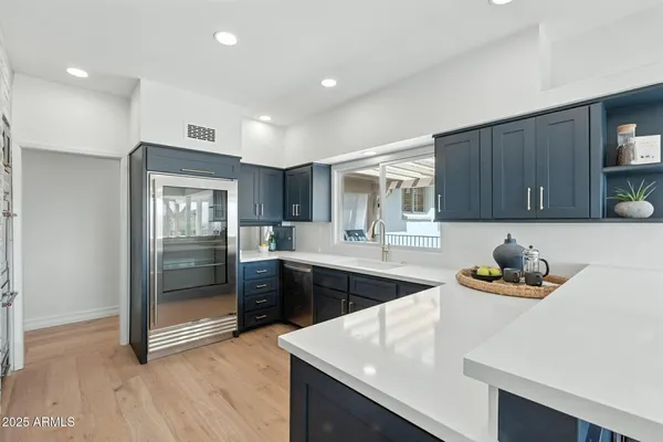 a kitchen with a granite countertop cabinets and a stove top oven
