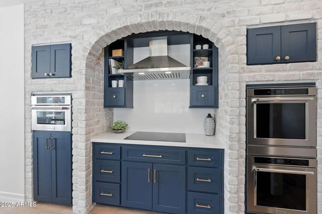 a kitchen and a dining table with a large window