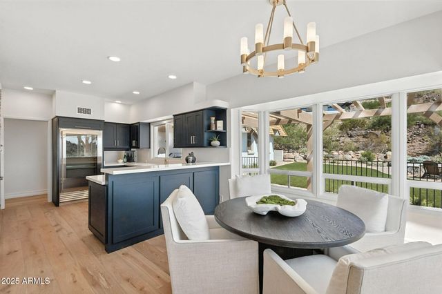 a dining room with furniture a chandelier and glass door