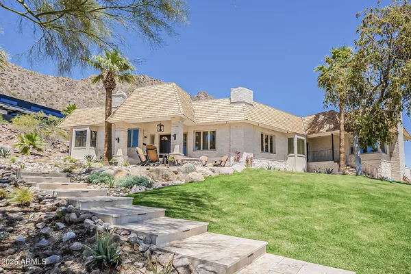 a front view of a house with garden and porch