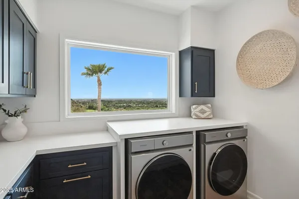 a living room with furniture large window and a fireplace