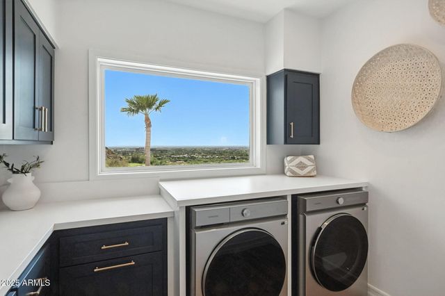 a living room with furniture large window and a fireplace