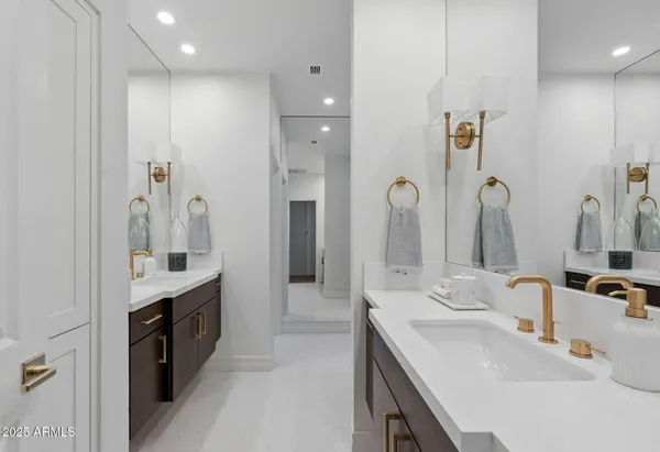 a bathroom with a tub a sink and a window