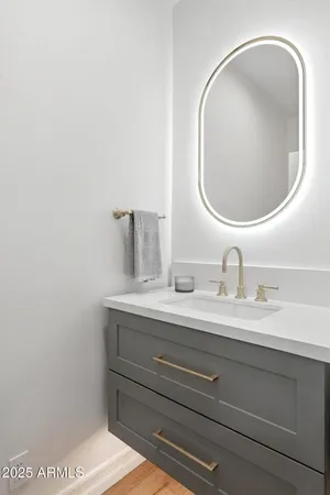 a bathroom with a sink double vanity granite and a mirror