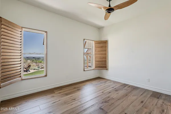 a view of a room with wooden floor and white walls