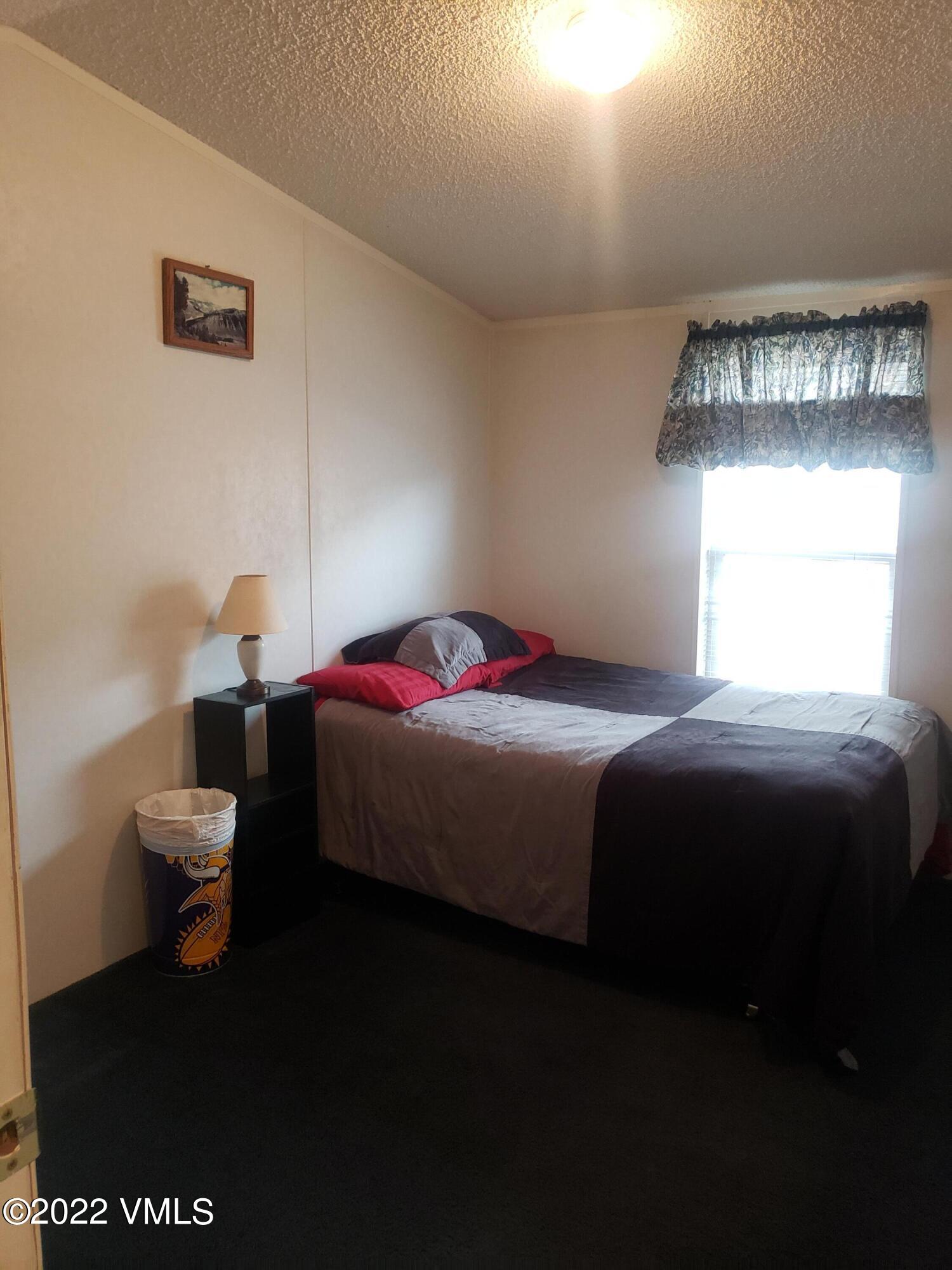 742 2nd Street Gypsum, CO 81637 - Photo 12 of 17 a bedroom with a bed and window