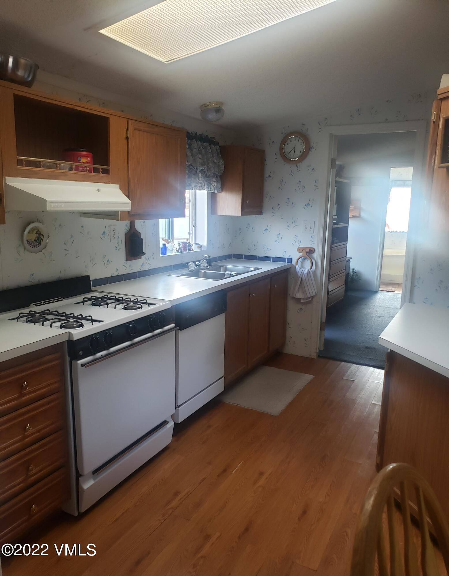 742 2nd Street Gypsum, CO 81637 - Photo 6 of 17 a kitchen with stainless steel appliances granite countertop a stove and a sink