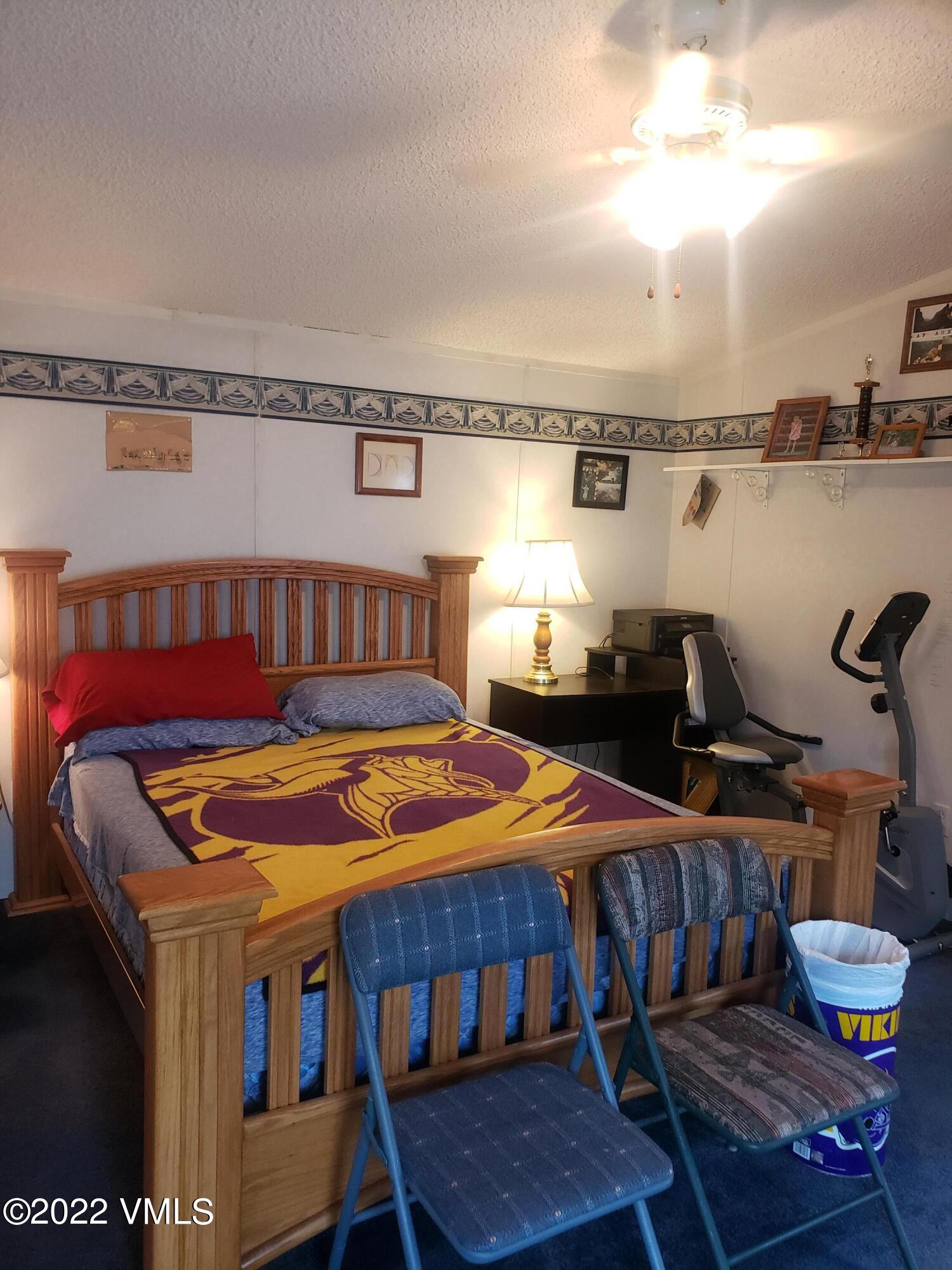 742 2nd Street Gypsum, CO 81637 - Photo 9 of 17 a bedroom with furniture and wooden floor