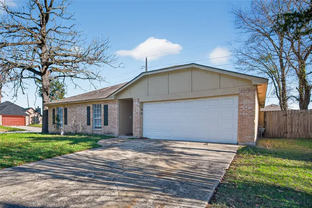 a front view of house with yard and trees around