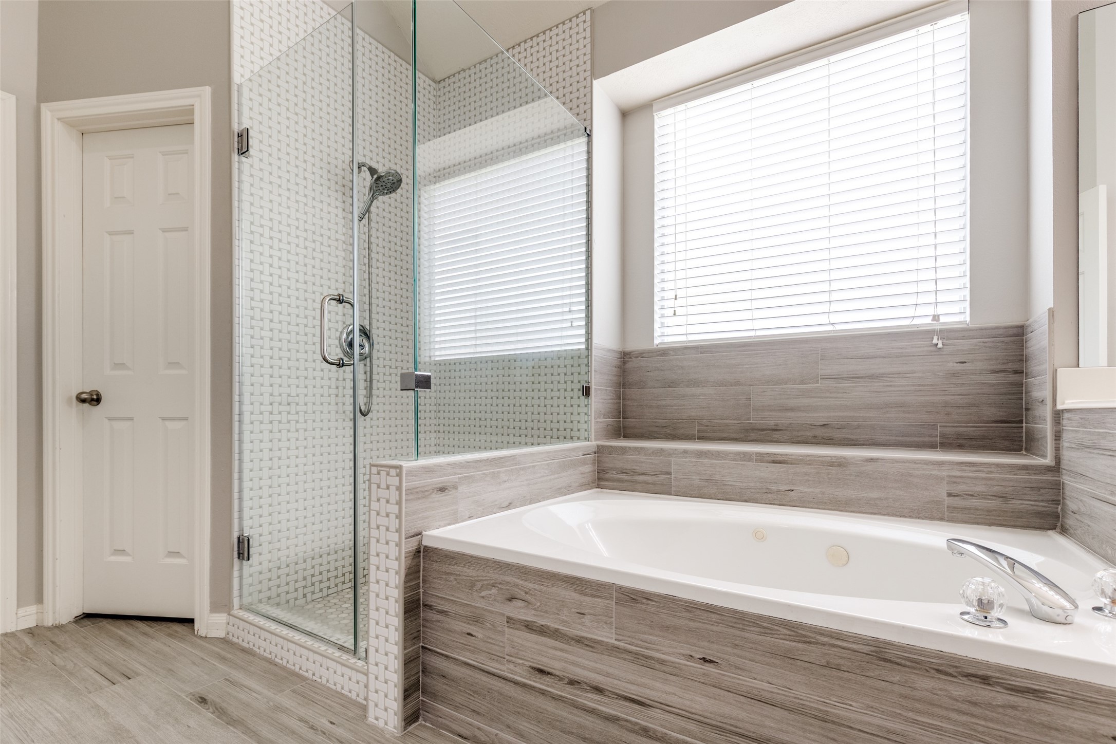 20710 Water Point Trail Humble, TX 77346 - Photo 14 of 29 Experience luxury in this beautifully updated primary bathroom, featuring a sleek glass-enclosed shower and a relaxing separate tub.