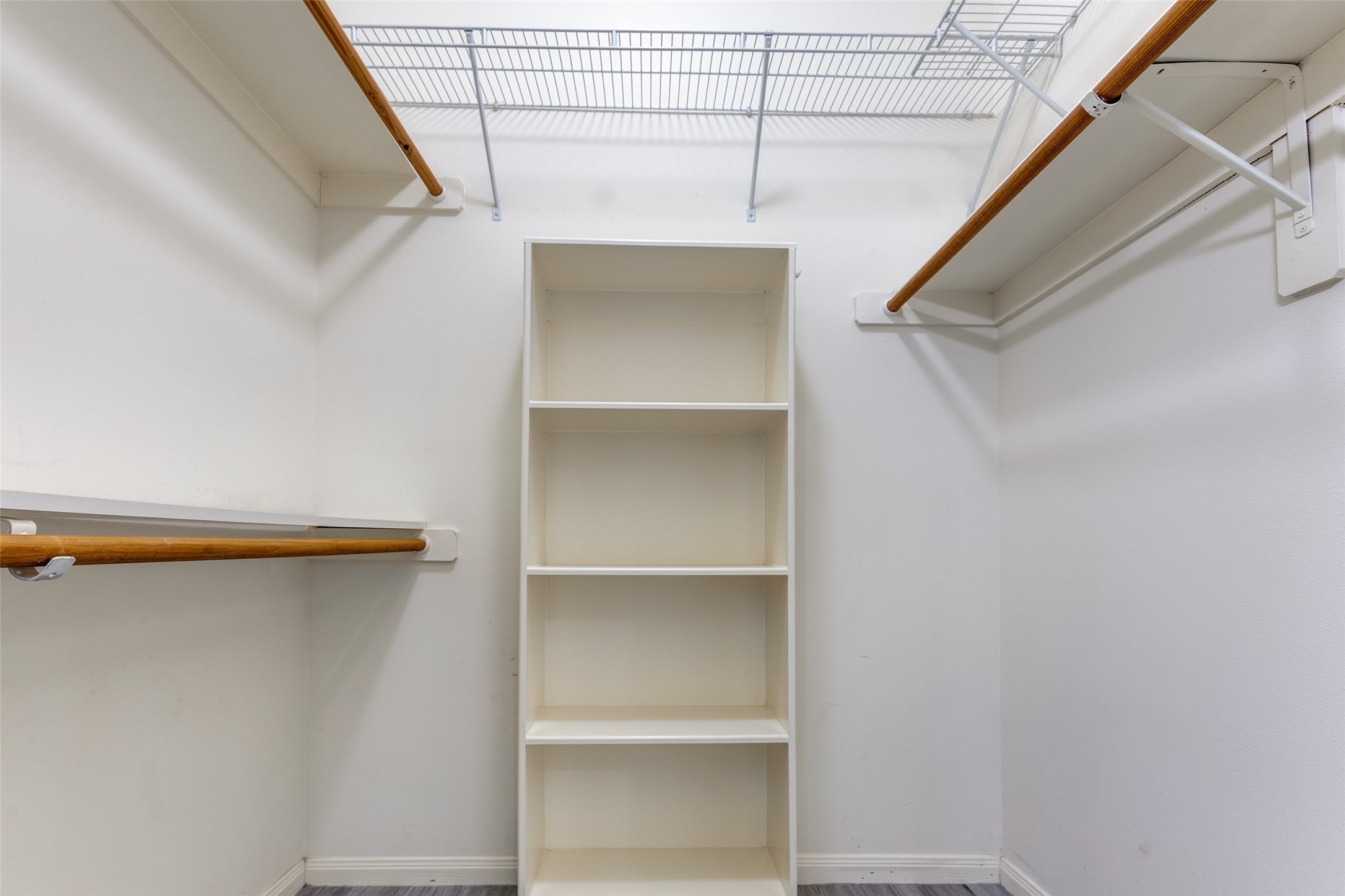 20710 Water Point Trail Humble, TX 77346 - Photo 16 of 29 Spread out in this spacious primary closet, the larger of the two, featuring ample shelving and hanging space for all your wardrobe needs.