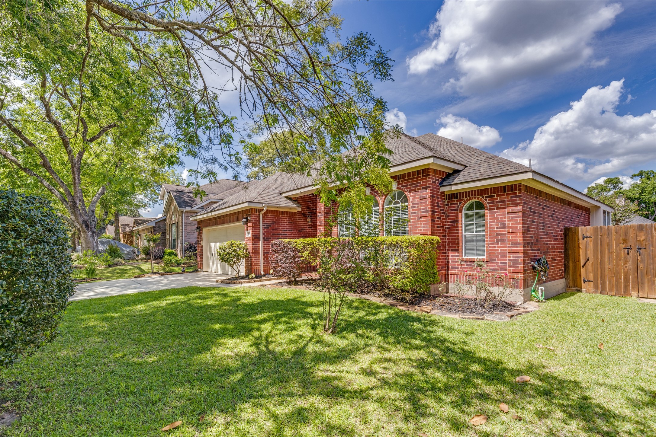 20710 Water Point Trail Humble, TX 77346 - Photo 2 of 29 Nestled in lush greenery, this home's inviting front lawn exudes warmth and a welcoming atmosphere.