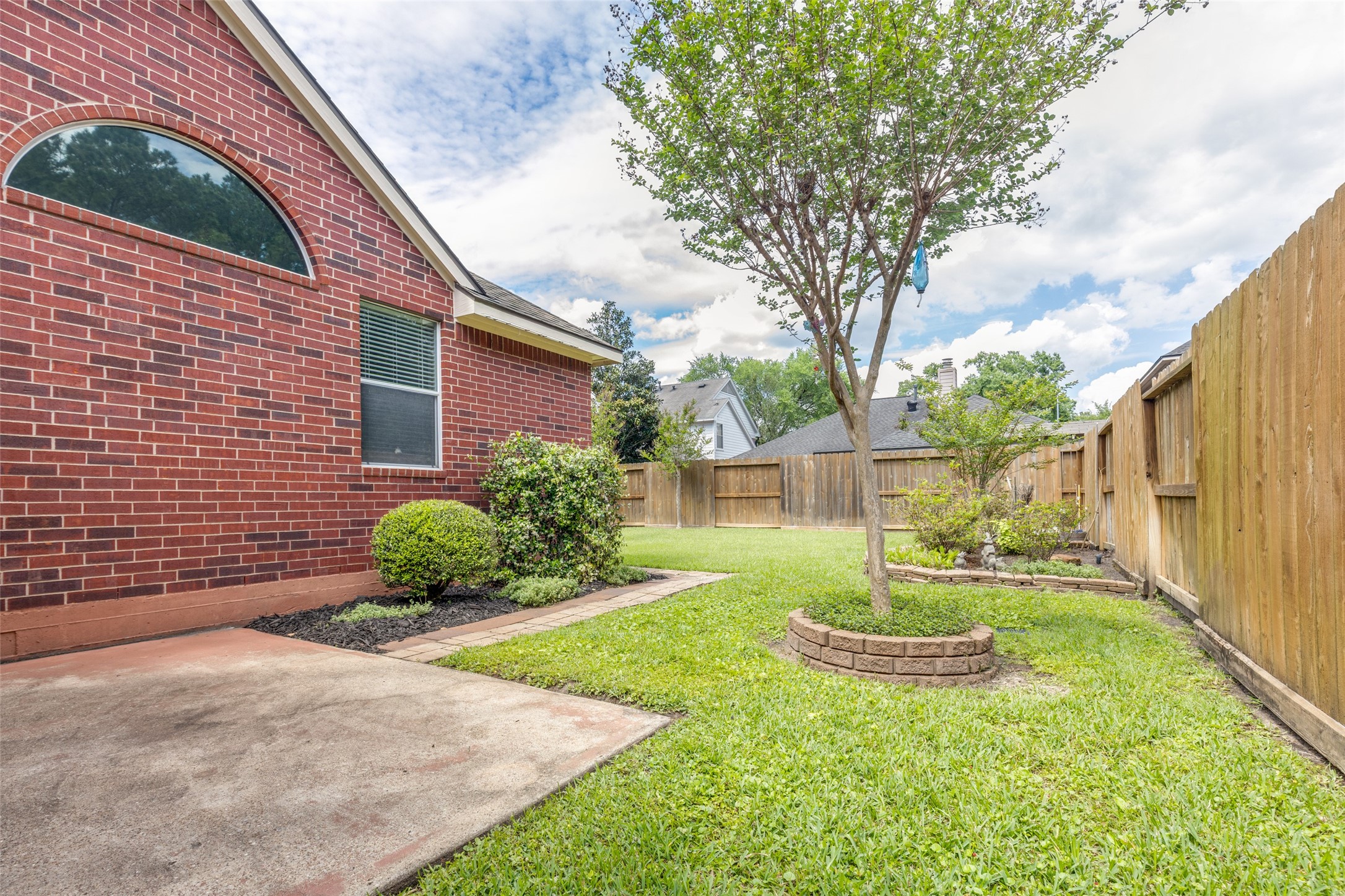20710 Water Point Trail Humble, TX 77346 - Photo 21 of 29 This inviting back patio offers a serene view of a beautifully landscaped garden, perfect for relaxation and outdoor enjoyment.