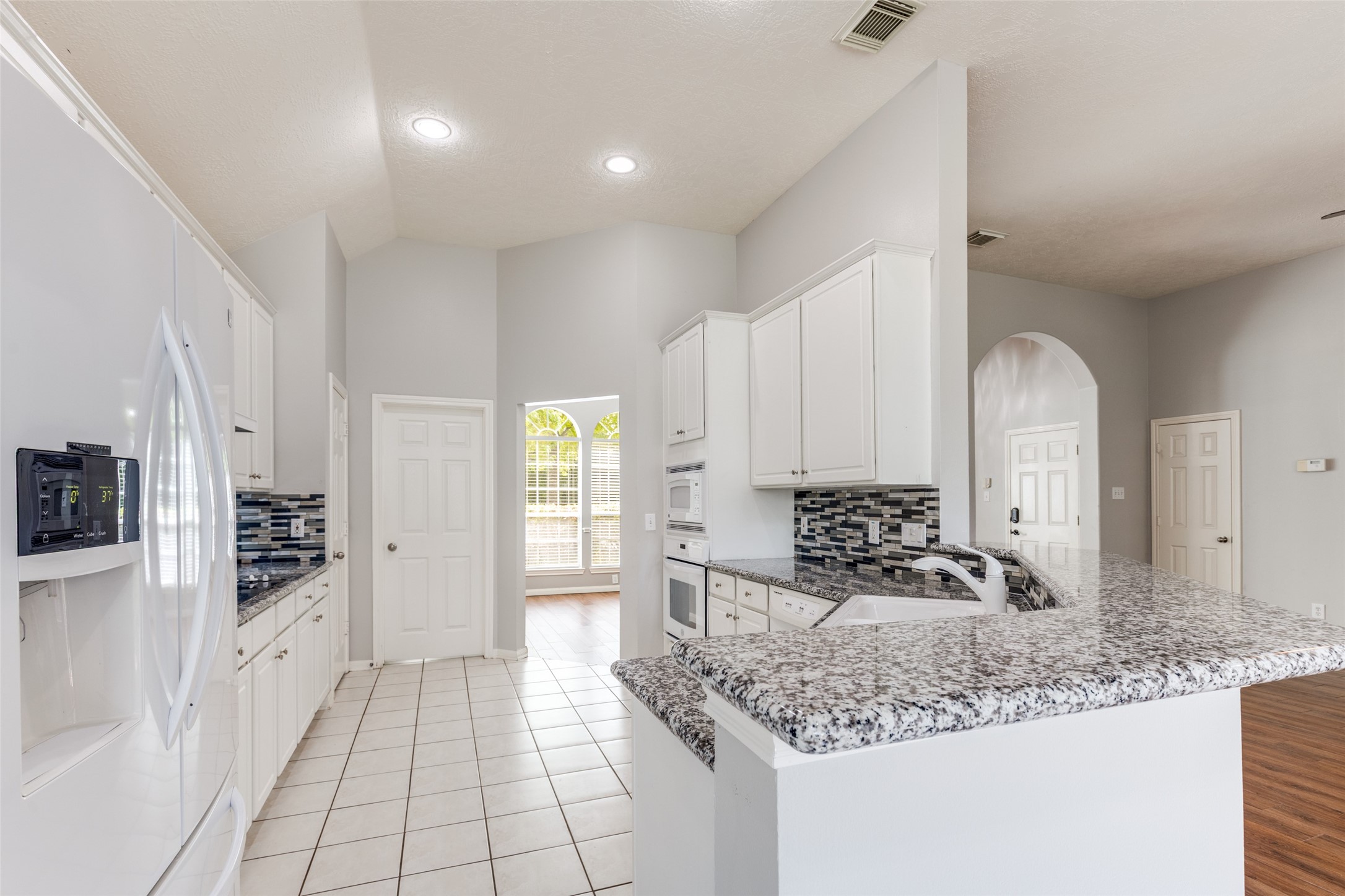 20710 Water Point Trail Humble, TX 77346 - Photo 9 of 29 The bright, functional kitchen has updated granite countertops and sleek white appliances.