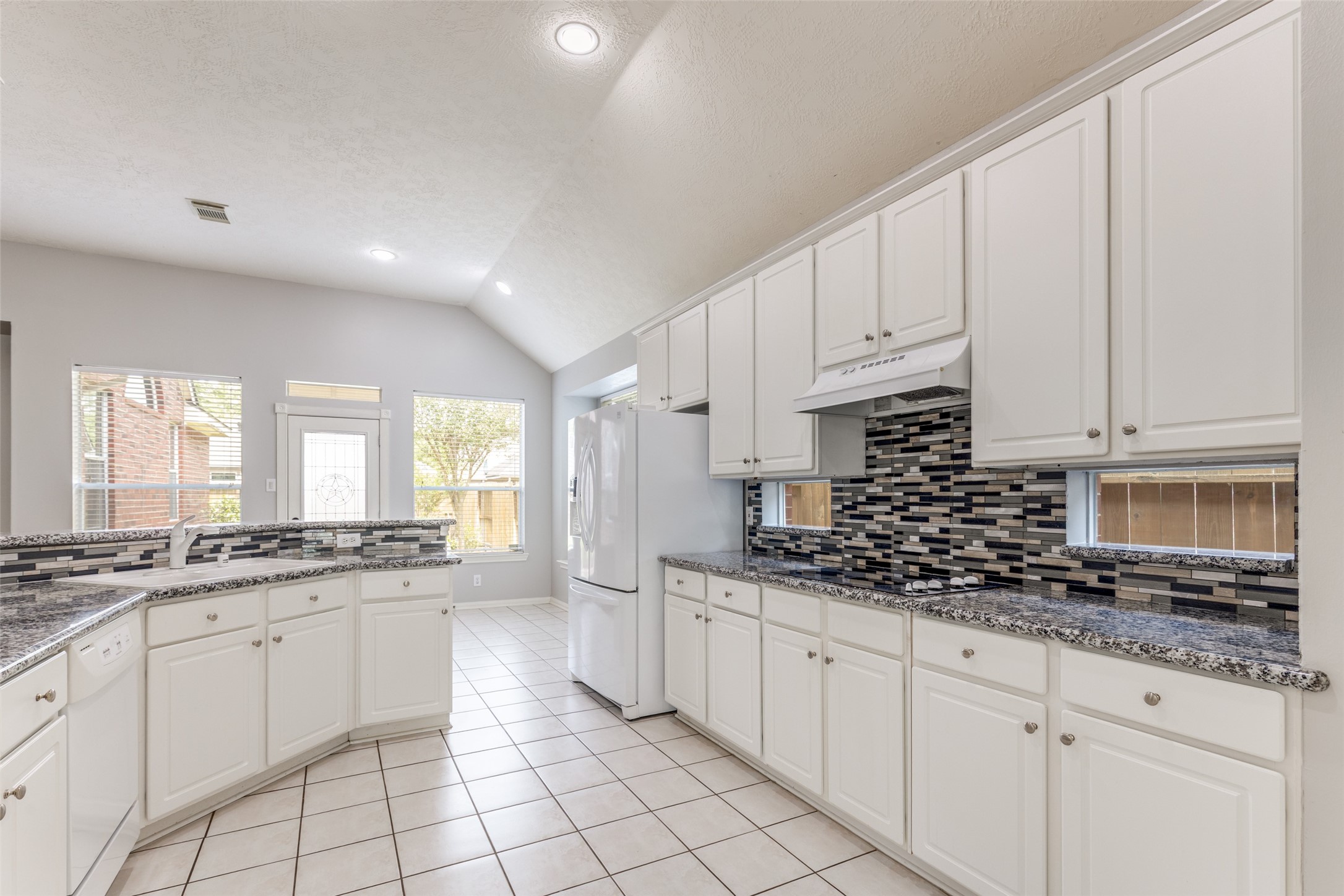 20710 Water Point Trail Humble, TX 77346 - Photo 10 of 29 The well-appointed kitchen provides a view of the gorgeous backyard space.