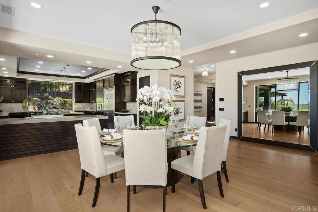 1159 Larksong Lane Encinitas, CA 92024 - Photo 14 of 68 a view of a dining room with furniture wooden floor and chandelier