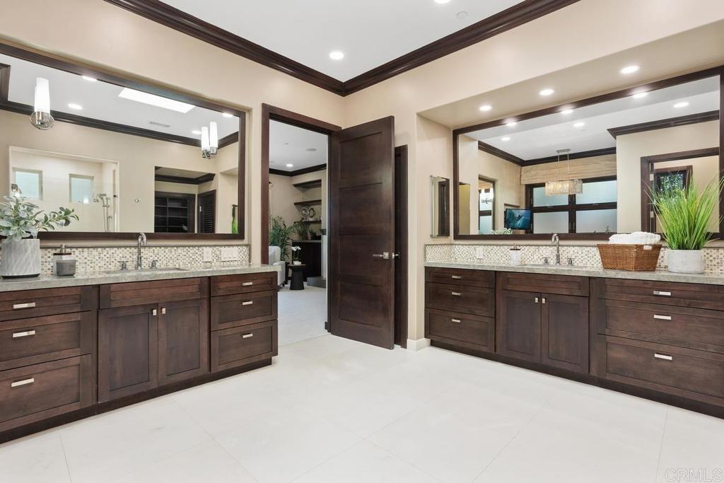 1159 Larksong Lane Encinitas, CA 92024 - Photo 30 of 68 a spacious bathroom with a granite countertop double vanity and a mirror