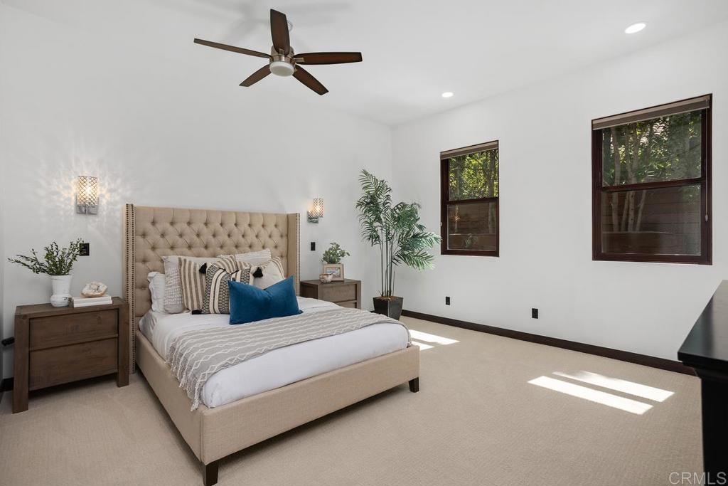 1159 Larksong Lane Encinitas, CA 92024 - Photo 33 of 68 a bedroom with a large bed and a chandelier