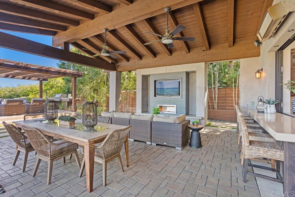 1159 Larksong Lane Encinitas, CA 92024 - Photo 49 of 68 a dining room with furniture a chandelier and wooden floor