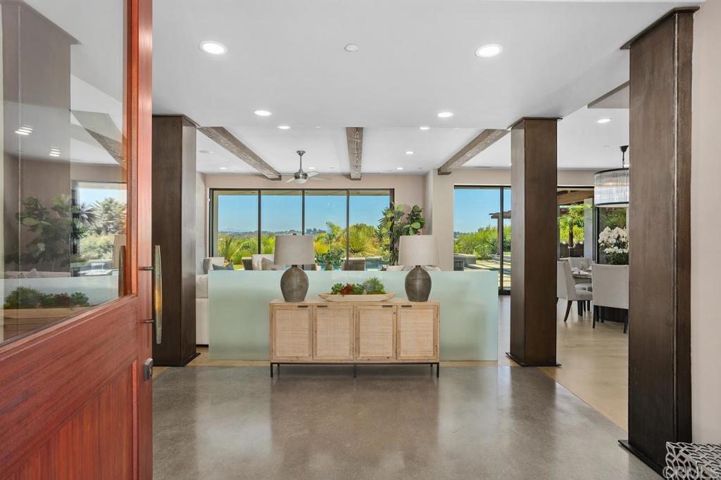 1159 Larksong Lane Encinitas, CA 92024 - Photo 9 of 68 a living room with furniture kitchen view and a large window