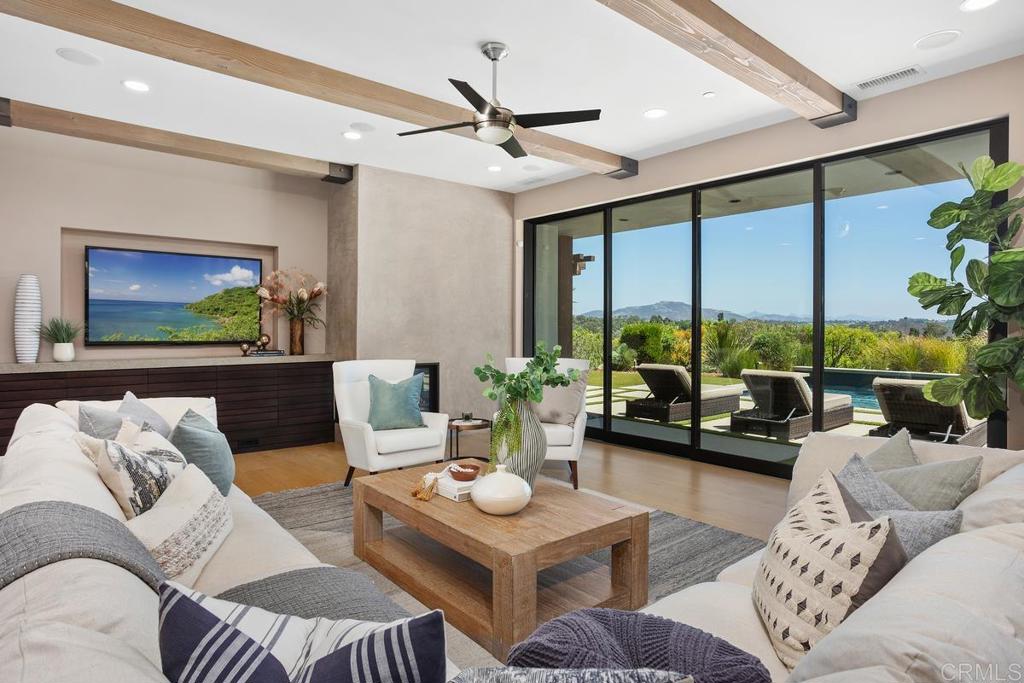1159 Larksong Lane Encinitas, CA 92024 - Photo 10 of 68 a living room with furniture and a large window