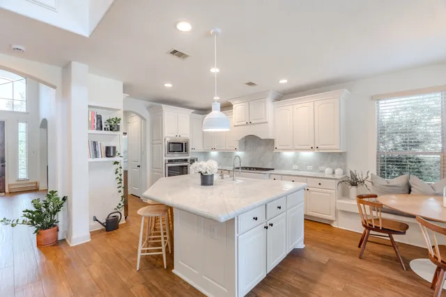 a kitchen with a stove a sink and a refrigerator