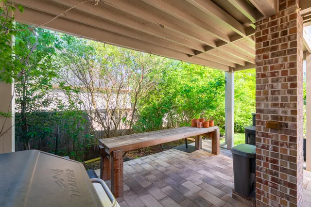 a view of backyard with green space and wooden fence