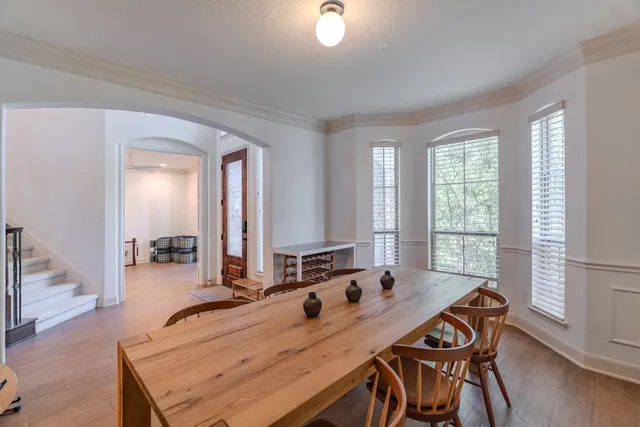a dining room with furniture and wooden floor