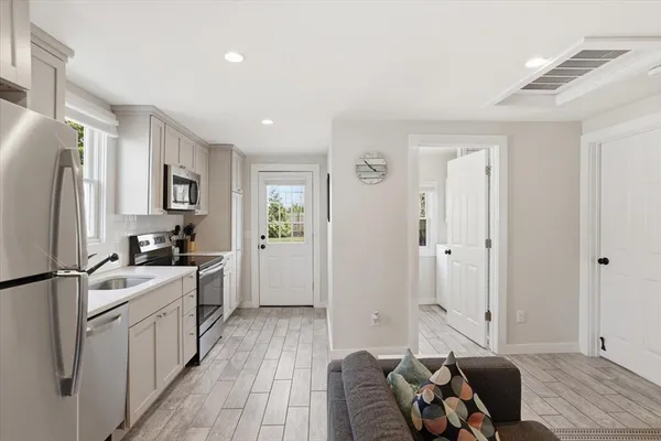 a kitchen with stainless steel appliances granite countertop a stove refrigerator and a refrigerator