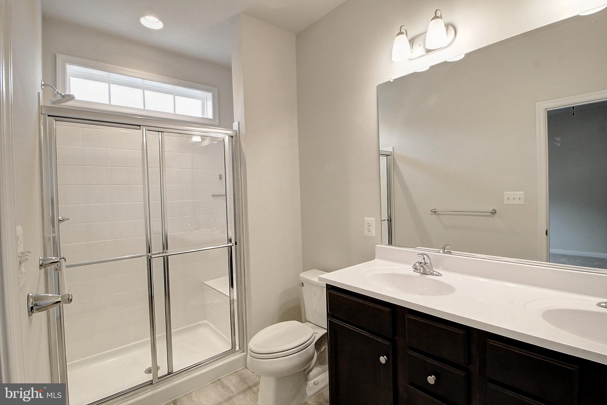304 Spring Bank Way Frederick, MD 21701 - Photo 17 of 27 a bathroom with a sink shower and a toilet