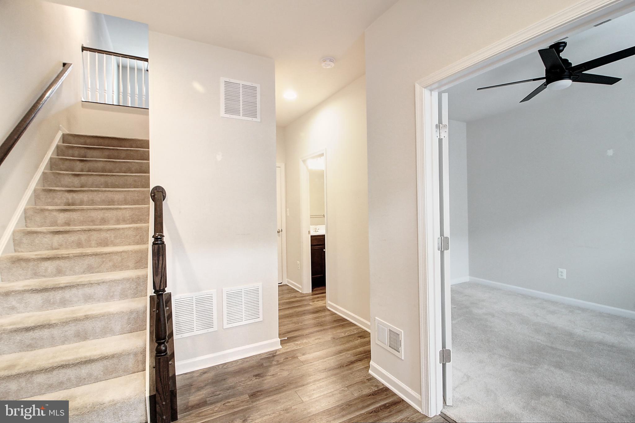 304 Spring Bank Way Frederick, MD 21701 - Photo 8 of 27 a view of an entryway with wooden floor and door