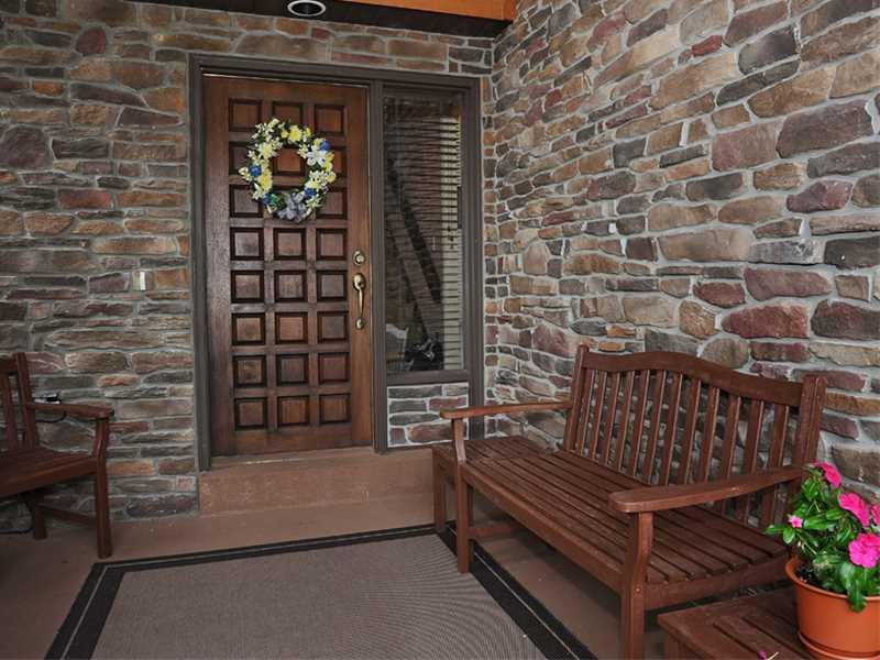 Facade/Exterior Front. covered front porch with mahogany front door