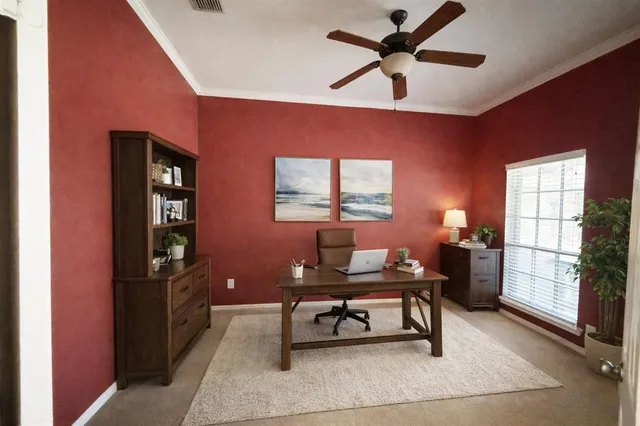 a living room with furniture a window and a ceiling fan
