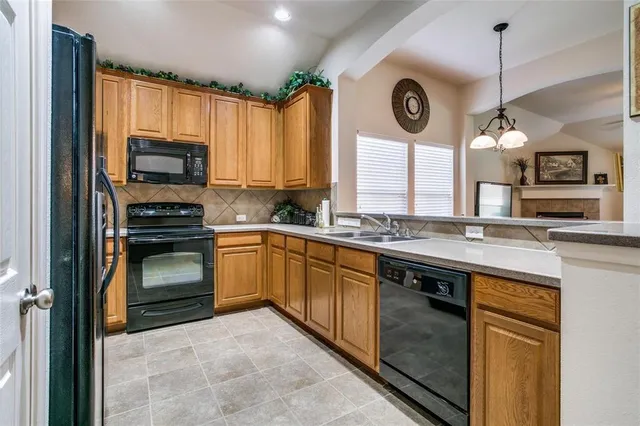 a kitchen with granite countertop a stove a sink and a microwave