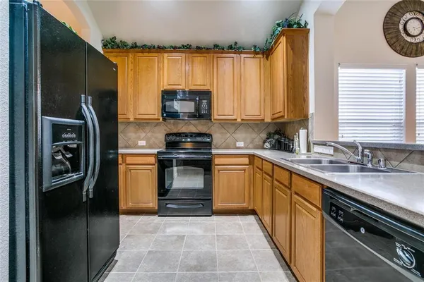 a kitchen with a refrigerator stove and sink