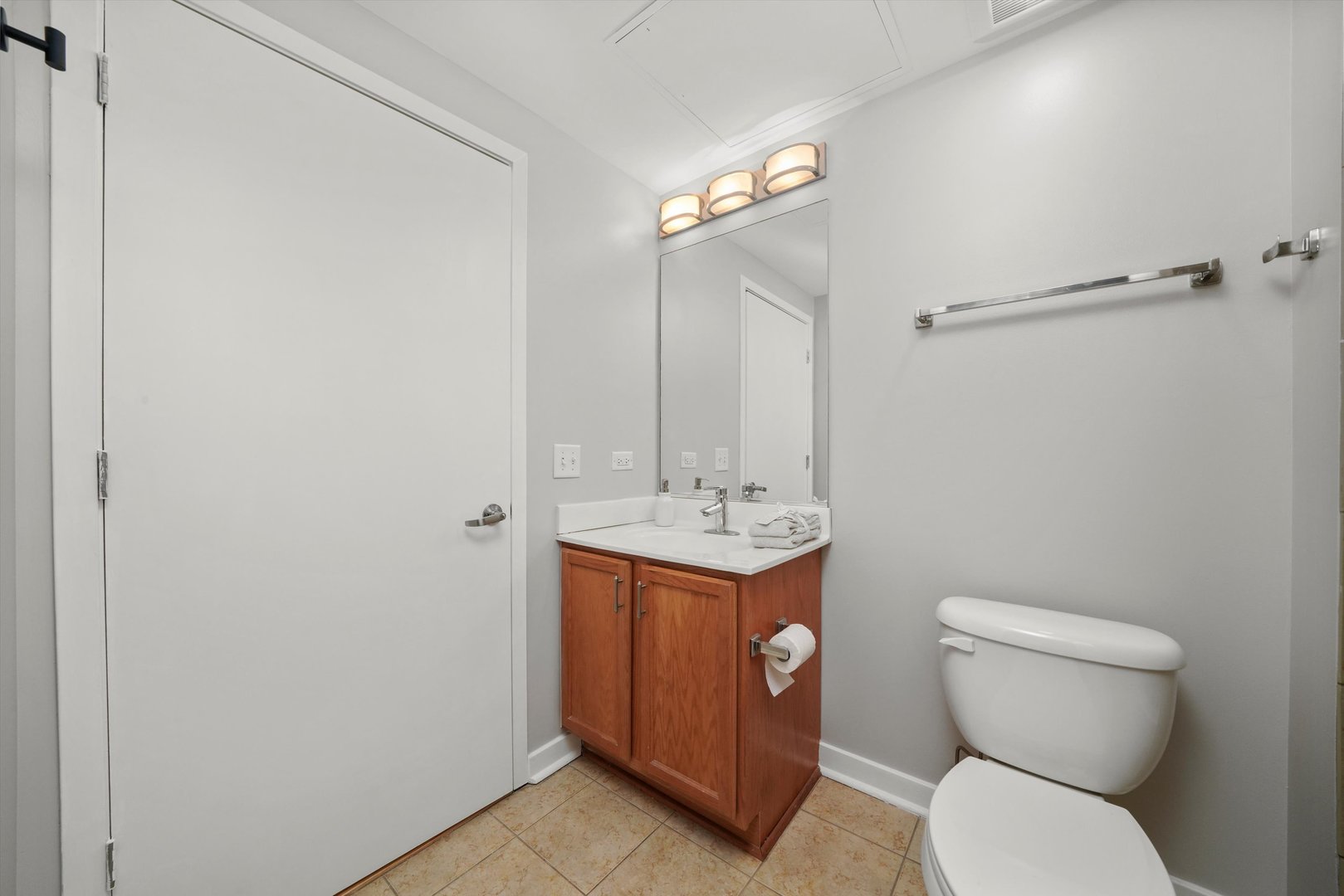 50 East 16th Street, Unit 414 Chicago, IL 60616 - Photo 14 of 26 a bathroom with a toilet a sink and mirror
