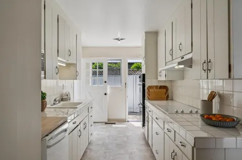 a kitchen with stainless steel appliances a sink stove and cabinets