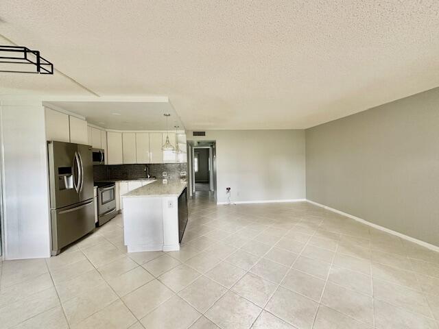 338 Fanshaw I Boca Raton, FL 33434 - Photo 25 of 28 a kitchen with stainless steel appliances a refrigerator and a stove top oven