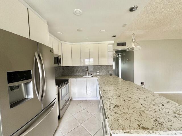 338 Fanshaw I Boca Raton, FL 33434 - Photo 2 of 28 a kitchen with stainless steel appliances granite countertop a refrigerator and a sink