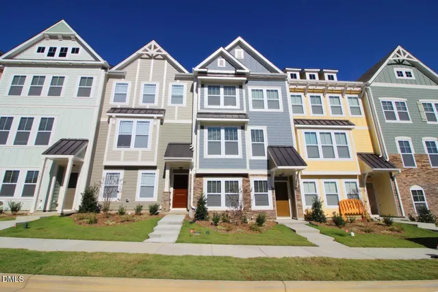 a front view of a residential apartment building with a yard