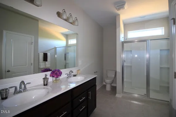 a bathroom with a double vanity sink and a mirror