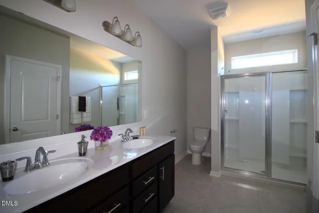 a bathroom with a double vanity sink and a mirror