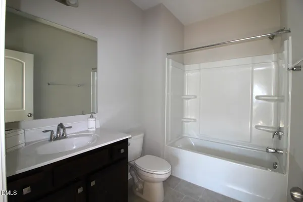 a bathroom with a sink toilet tub and shower