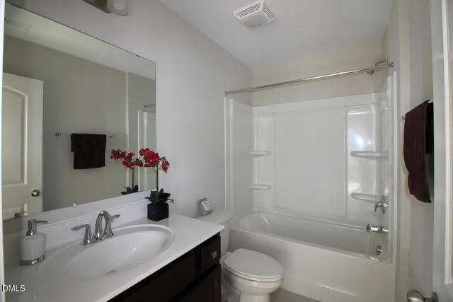 a bathroom with a sink toilet tub and shower