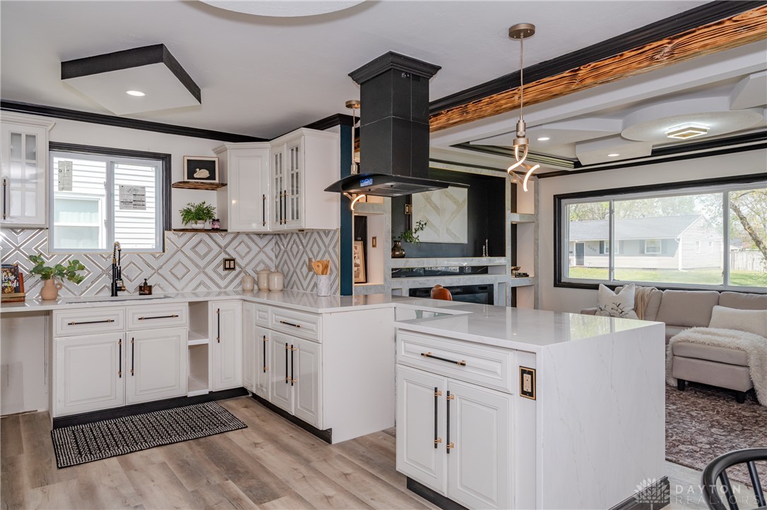 5240 Haverfield Road Dayton, OH 45432 - Photo 18 of 58 This modern kitchen features a stylish island and sleek cabinetry, perfect for culinary endeavors and entertaining.