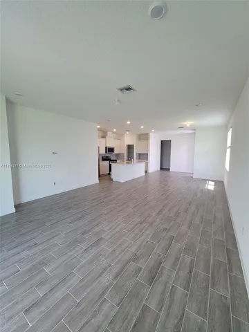 a view of a hall with wooden floor